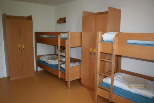 a room with three bunk beds and twounks at Jugendherberge Tübingen in Tübingen
