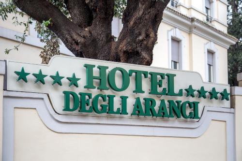 a sign on a building with a tree at Hotel Degli Aranci in Rome