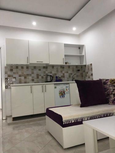 a living room with a couch and a kitchen at Queen Kodre Apartments in Ulcinj