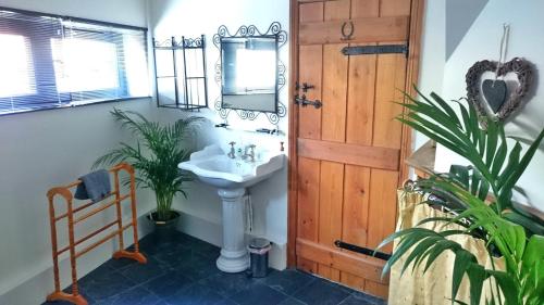 a bathroom with a sink and a mirror at The Stables in Southwell in Southwell