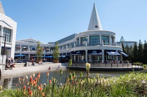 a building with a tower on the side of a river at 118 Shepherds Lane in Dartford