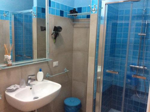 a bathroom with a sink and a shower at Alghero Sunrise in Alghero