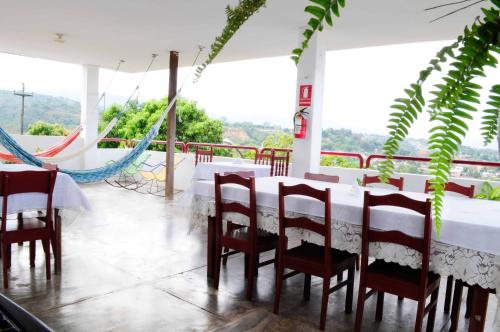 a dining room with a white table and chairs at El Mirador in Tarapoto