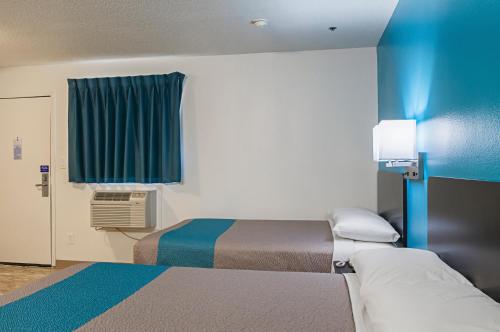 a small room with two beds and a window at Motel 6-Bay Saint Louis, MS in Bay Saint Louis