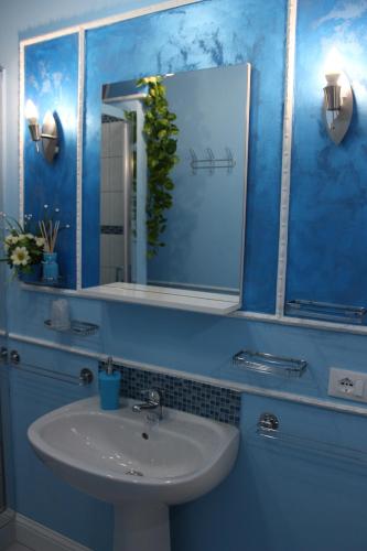 a bathroom with a sink and a mirror at La Dea Hestia in Bosa