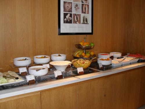 a buffet with bowls of food on a table at Napa Mermaid Hotel & Suites in Ayia Napa
