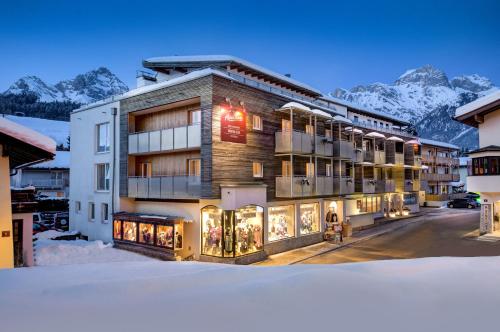 a hotel in the mountains with snow on the ground at AlpenParks Hotel Maria Alm in Maria Alm am Steinernen Meer