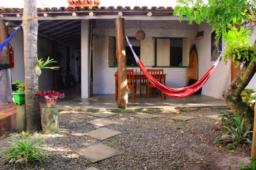 a hammock on the porch of a house at Pousada Vila Mundi Itaúnas in Itaúnas
