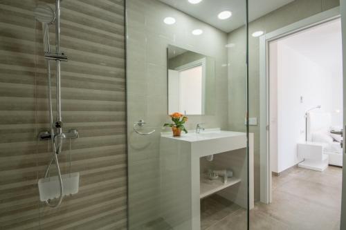 a bathroom with a shower and a sink and a mirror at Son Serra de Marina - 1930-45 Mallorca in Son Serra de Marina