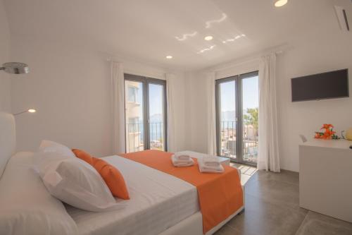 a white bedroom with a bed and a large window at Son Serra de Marina - 1930-45 Mallorca in Son Serra de Marina