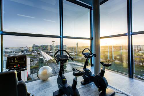 a gym with two exercise bikes in a window at Novotel Paris Coeur d'Orly Airport in Orly