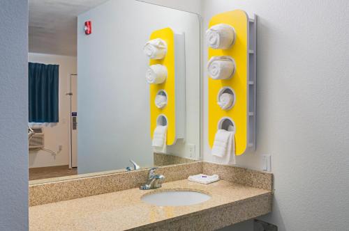 a bathroom with a sink and a mirror at Motel 6-Bay Saint Louis, MS in Bay Saint Louis