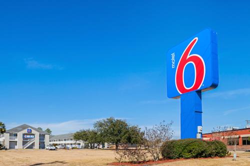 a gas station sign in front of a building at Motel 6-Bay Saint Louis, MS in Bay Saint Louis