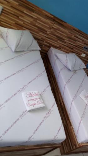 two white cushions in a wicker bed at Hotel Carpe Diem in Sao Paulo