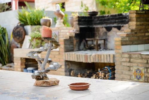 a statue sitting on a patio with a fireplace at Lo Racó de Peret in Camarles