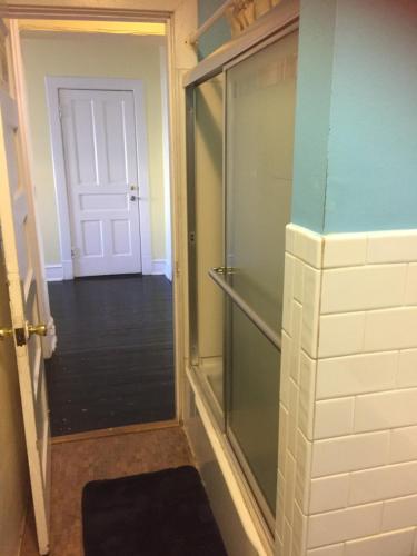 a glass shower in a room with a door at Washington International Student Center in Washington