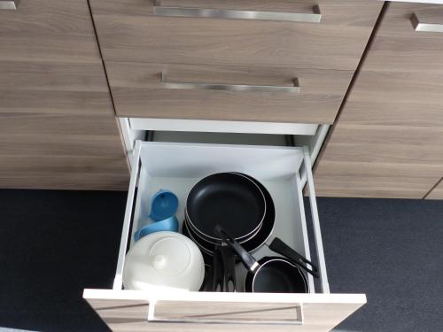 a cupboard with dishes and utensils in it at volcaloft in Orcines