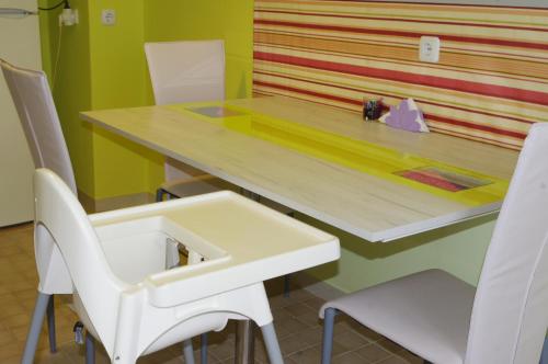 a table and chairs in a room with a table and a table and chairsktop at Jázmin Apartman in Szeged