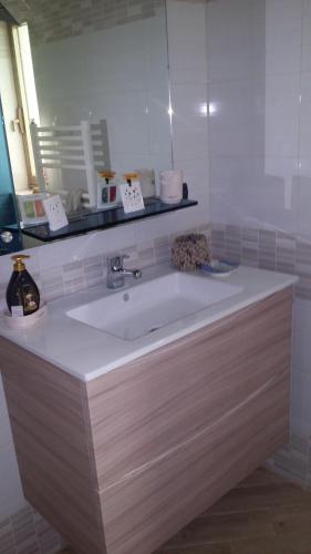 a bathroom with a white sink and a mirror at Villa Daniela e Rebecca in Fontane Bianche