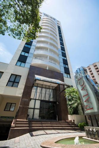 a tall building with stairs in front of it at Tsue The Palace Flats in Sao Paulo