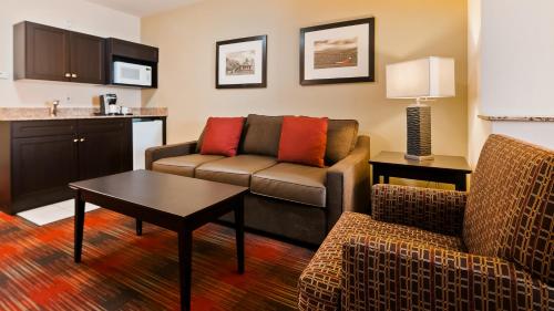 a living room with a couch and a table at Best Western Plus Red Deer Inn & Suite in Red Deer