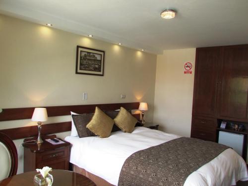 Ein Bett oder Betten in einem Zimmer der Unterkunft Queen's Villa Hotel Boutique