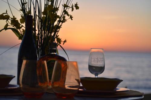 a table with a bottle of wine and a glass at La Mansión Residency Suites Ensenada in Ensenada