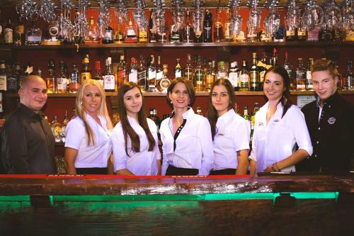 a group of people standing behind a bar at Šnekolend in Rokytnice nad Jizerou