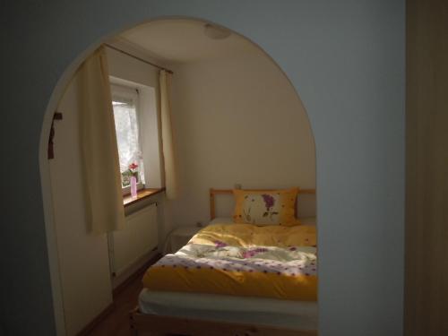 a small bedroom with a bed in an archway at Angelas Apartment in Grenzach-Wyhlen