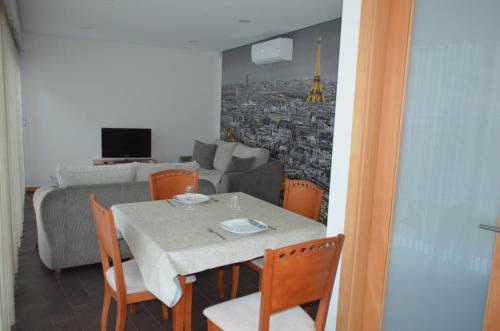 a dining room with a table and a couch at Quinta das Cutamas in Pedrouços