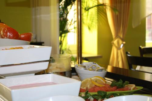 a table topped with a plate of fruit and vegetables at Hotel Berlin in Leipzig