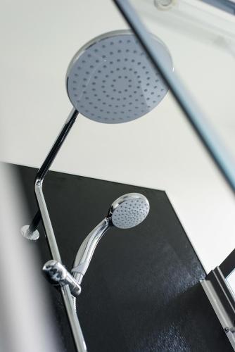 a shower head sitting on top of a mirror at The Roseburn Apartment in Edinburgh