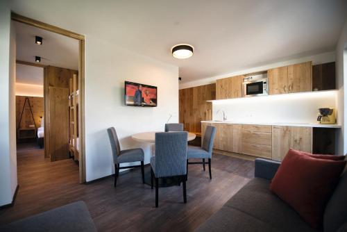 a kitchen and dining room with a table and chairs at Appartements Bergheim St Andrä bei Brixen in Bressanone