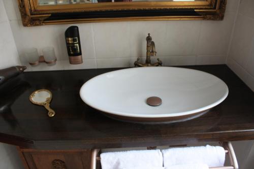 a white sink in a bathroom with a mirror at Hotel Berlin in Leipzig