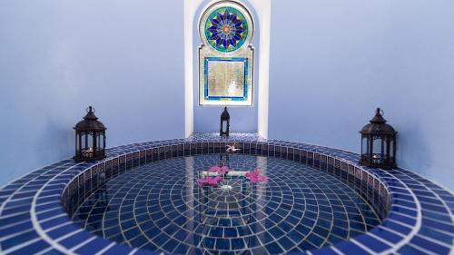 a swimming pool in a room with a stained glass window at Casa Estrella de la Valenciana Hotel Boutique in Guanajuato