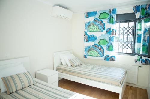 a room with two beds and a window at Apartamento Ideal 2 in Lisbon