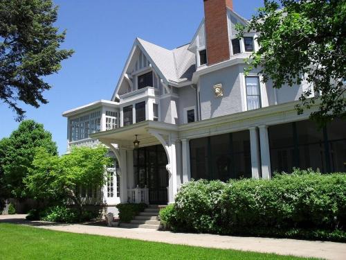 a large white house with a brick at Alexander Mansion Bed & Breakfast in Winona