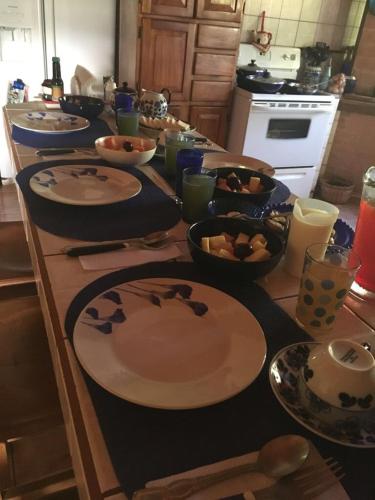 a kitchen counter with plates and bowls of food on it at Casa Cora Bed and Breakfast in Colonia Carmona