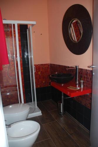 a bathroom with a toilet and a sink and a shower at La Rosa dei Venti Resort in Piombino