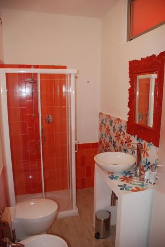 a bathroom with a shower and a toilet and a sink at La Rosa dei Venti Resort in Piombino