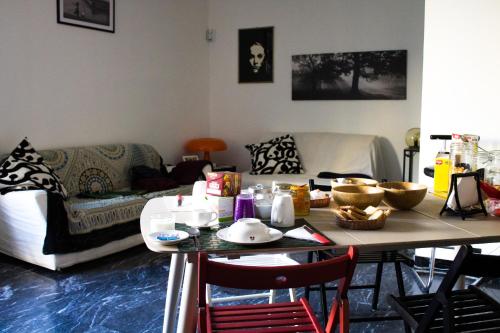 a living room with a table and a couch at A due passi dal Lumière in Bologna
