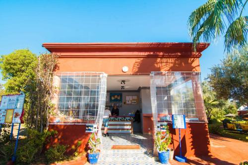 a store front of a building with a palm tree at Le Relais De Marrakech in Marrakech