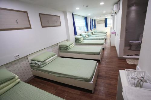 a row of bunk beds in a room at Namsan Guesthouse in Seoul
