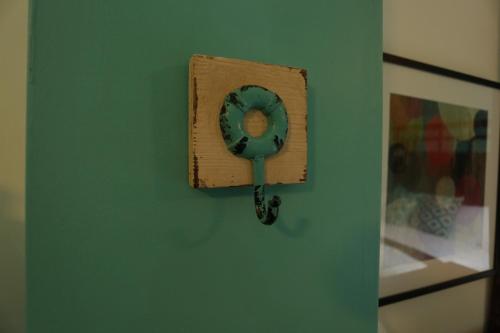 a mirror on a wall on a green wall at Trojan House in Ensenada