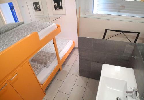 a bathroom with a bunk bed and a sink at Residenza Acapulco App 1977 in Ronco sopra Ascona