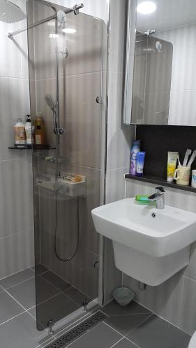a bathroom with a shower and a white sink at Haetmom House in Gangneung