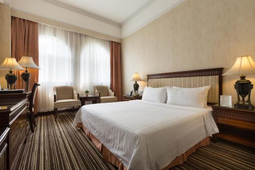 Grand Palace Hotel - Grand Hotel Management Group tesisinde bir odada yatak veya yataklar