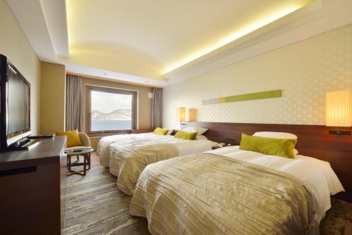 Cama o camas de una habitación en Toya Sun Palace Resort & Spa