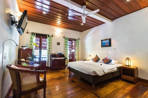 a bedroom with a bed and a desk in a room at Mekong Riverview Hotel in Luang Prabang