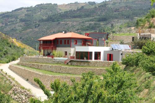 a house on the side of a mountain at Quinta dos Padres Santos, Agroturismo & Spa in Lamego
